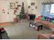 Inviting living room with comfortable furniture, a Christmas tree, fireplace, and natural light from sliding glass door at 100 G Myrtle Greens Dr. # G, Conway, SC 29526