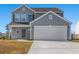 Charming two-story home featuring a two-car garage and well-maintained front yard on a sunny day at 2053 Haystack Way, Myrtle Beach, SC 29579