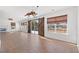Open-concept living room featuring modern lighting, wood floors, and a rustic barn door at 2053 Haystack Way, Myrtle Beach, SC 29579
