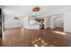 Bright, open-concept living room with wood-look tile floors, modern lighting, and updated kitchen at 2053 Haystack Way, Myrtle Beach, SC 29579