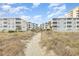 Beachfront property with boardwalk path leading to the sandy shore at 2405 S Ocean Blvd. # 207, North Myrtle Beach, SC 29582