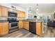 Open kitchen features stainless steel appliances and granite countertops at 2405 S Ocean Blvd. # 207, North Myrtle Beach, SC 29582