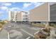 Parking lot with beach house and surrounding buildings in background at 2405 S Ocean Blvd. # 207, North Myrtle Beach, SC 29582