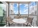 Ocean view screened balcony with table and chairs at 2405 S Ocean Blvd. # 207, North Myrtle Beach, SC 29582