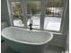 Bathroom showcasing standalone tub with outdoor views from large windows at 2708 Main St., Loris, SC 29569