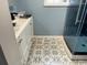 Bathroom featuring an elegant vanity with tiled floors and glass enclosed shower at 2708 Main St., Loris, SC 29569