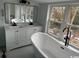 Bright bathroom with a double sink vanity, standalone tub, and a large window at 2708 Main St., Loris, SC 29569