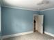 Bedroom with new carpeting, blue walls, white trim, and a modern ceiling fixture at 2708 Main St., Loris, SC 29569