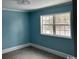 Bedroom with new carpeting, blue walls, white trim, and a window at 2708 Main St., Loris, SC 29569