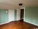 Bedroom with hardwood floors and mint green walls at 2708 Main St., Loris, SC 29569