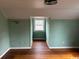 Bedroom with hardwood floors and mint green walls at 2708 Main St., Loris, SC 29569