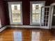 Bedroom with hardwood floors, two windows, and freshly painted walls at 2708 Main St., Loris, SC 29569