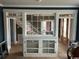 Dining room with built-in cabinet and large windows looking into other spaces at 2708 Main St., Loris, SC 29569