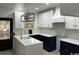 Contemporary kitchen featuring navy blue lower cabinets, white upper cabinets, and a center island at 2708 Main St., Loris, SC 29569
