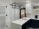 Contemporary kitchen featuring navy blue lower cabinets, white upper cabinets, and a center island at 2708 Main St., Loris, SC 29569