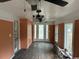 A covered porch with rustic charm, featuring vintage ceiling fans and orange paneled walls at 2708 Main St., Loris, SC 29569