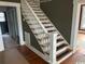 Traditional staircase with white railings and stained wood steps in home's interior at 2708 Main St., Loris, SC 29569
