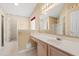 Bright bathroom featuring a vanity with sink, large mirror, and walk-in shower at 352 Mckendree Ln., Myrtle Beach, SC 29579