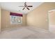 This bedroom features neutral carpet and fan, and a window with wooded views at 352 Mckendree Ln., Myrtle Beach, SC 29579