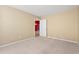 Bright bedroom with neutral walls, beige carpet, and an open door with a view into the house at 352 Mckendree Ln., Myrtle Beach, SC 29579