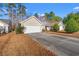 Exterior view of home showcasing large driveway, two car garage, and lawn at 352 Mckendree Ln., Myrtle Beach, SC 29579