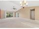 Vaulted ceiling living room with ceiling fan, glass doors and tan carpet at 352 Mckendree Ln., Myrtle Beach, SC 29579
