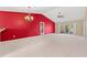 Open living room boasts bright red accent wall, neutral carpet and sliding glass door to yard at 352 Mckendree Ln., Myrtle Beach, SC 29579