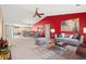 Open-concept living room with eat-in kitchen, red accent wall and modern gray sofa at 352 Mckendree Ln., Myrtle Beach, SC 29579