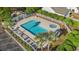 Aerial view of a community pool and hot tub surrounded by a white fence and lush landscaping at 352 Mckendree Ln., Myrtle Beach, SC 29579