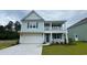 Charming two-story home featuring a welcoming front porch and attached garage at 6056 Forest Dell Ct, Myrtle Beach, SC 29579