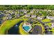 Aerial view displaying a community pool and a pond, alongside residential homes and lush greenery at 607 Sunnyside Dr. # 201, Murrells Inlet, SC 29576