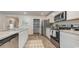 Well-equipped kitchen with stainless steel appliances, granite countertops, white cabinets, and a walk-in pantry at 71 Arbor Crest Ln., Tabor City, NC 28463