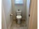 Powder room features a standard toilet, tile flooring, and neutral-colored walls at 914 Mary Read Dr., North Myrtle Beach, SC 29582