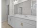 Bathroom featuring a double vanity with white countertops, a large mirror, and neutral paint at 1200 Nw Calabash Station Blvd., Calabash, NC 28467