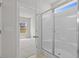 Bathroom showing walk-in shower with tile surround; bedroom with natural light is visible through door at 1200 Nw Calabash Station Blvd., Calabash, NC 28467