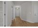 Bright hallway with wood-look floors, white trim, and a view of the front door at 1200 Nw Calabash Station Blvd., Calabash, NC 28467