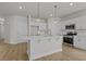 Elegant kitchen featuring white cabinets, modern lighting, stainless steel appliances, and a center island at 1200 Nw Calabash Station Blvd., Calabash, NC 28467
