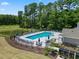 Community pool area with lounge chairs, a pond, and lush landscaping within a residential neighborhood at 1200 Nw Calabash Station Blvd., Calabash, NC 28467