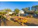 Outdoor picnic and grilling area with tables and palm trees, next to a parking lot and light yellow building at 1310 River Oaks Dr. # 2J, Myrtle Beach, SC 29579