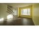 Bright living room with staircase and entry, featuring modern wood-look floors at 2925 Carriage Row Ln. # 145, Myrtle Beach, SC 29577