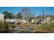 Exterior view of the townhome complex showcasing mature landscaping and convenient parking at 2925 Carriage Row Ln. # 145, Myrtle Beach, SC 29577
