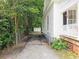 Side view of the home with a driveway leading to a shed in the backyard at 306 E Godbold St., Marion, SC 29571