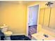 Bathroom with toilet, vanity, and a view into another room at 306 E Godbold St., Marion, SC 29571