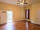 Bedroom featuring light yellow walls, wood floors, and a ceiling fan with access to a porch at 306 E Godbold St., Marion, SC 29571