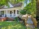 Charming home exterior features a cozy front porch and a ramp for accessibility at 306 E Godbold St., Marion, SC 29571