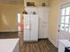 This kitchen has plenty of cabinet space, light yellow walls, and a refrigerator at 306 E Godbold St., Marion, SC 29571