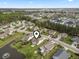 Aerial view showcasing neighborhood landscape and a community lake at 1133 Spalding Ct., Surfside Beach, SC 29575
