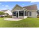 An enclosed back porch and patio overlooks a lush, green yard, perfect for outdoor living at 1133 Spalding Ct., Surfside Beach, SC 29575