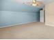 Spacious bedroom with neutral carpet, ceiling fan, and door at 1133 Spalding Ct., Surfside Beach, SC 29575