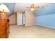 Cozy bedroom featuring a ceiling fan, blue accent walls, and a large dresser at 1133 Spalding Ct., Surfside Beach, SC 29575